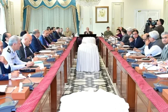 Government officials and ministers seated around a long conference table in Islamabad, discussing the extension of austerity measures and revised business hours until June 30, 2026.