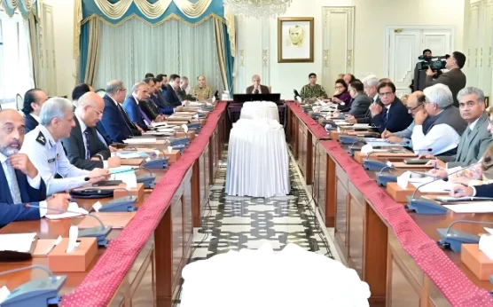 Government officials and ministers seated around a long conference table in Islamabad, discussing the extension of austerity measures and revised business hours until June 30, 2026.