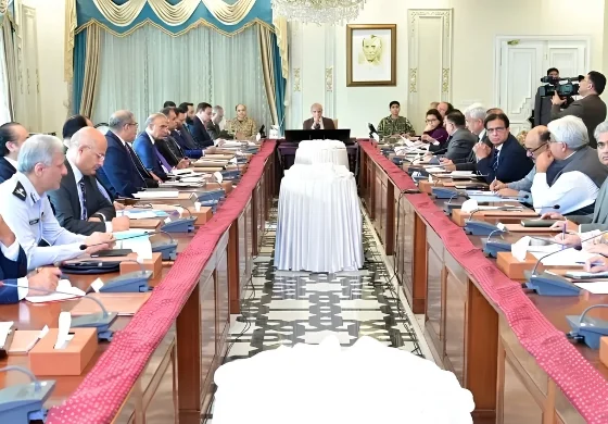 Government officials and ministers seated around a long conference table in Islamabad, discussing the extension of austerity measures and revised business hours until June 30, 2026.