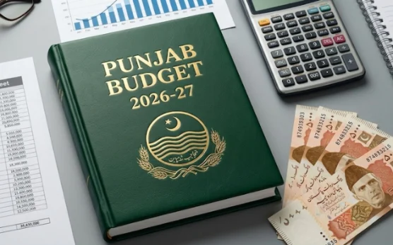 Punjab Budget 2026-27 document placed on a desk alongside Pakistani currency notes, a calculator, a notebook, and financial charts, representing fiscal planning, development allocations, and budget preparation for the province.